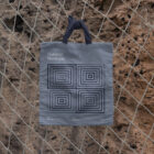 Outdoor branding mockups scene with canvas bag on the net.