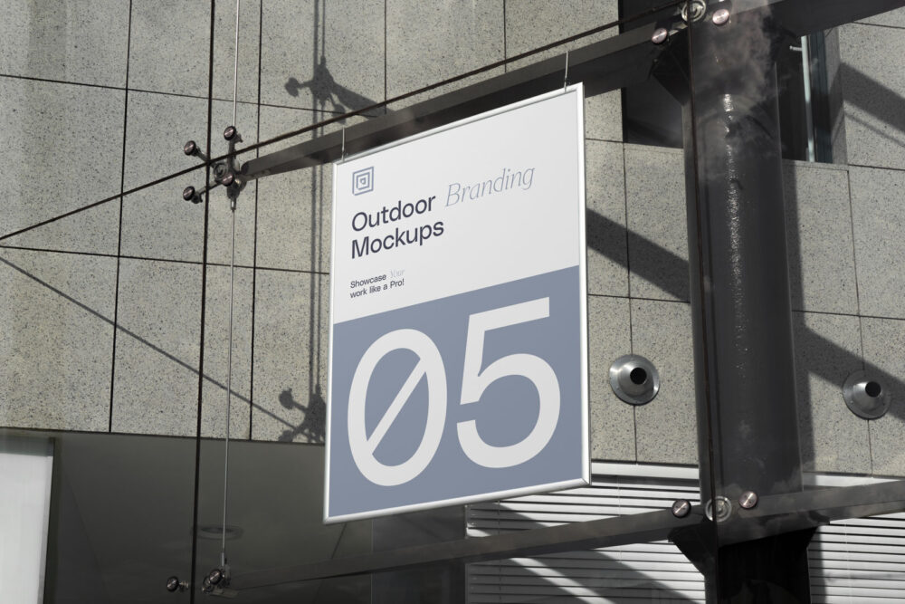 Hanging poster on the modern building from outdoor branding mockups.