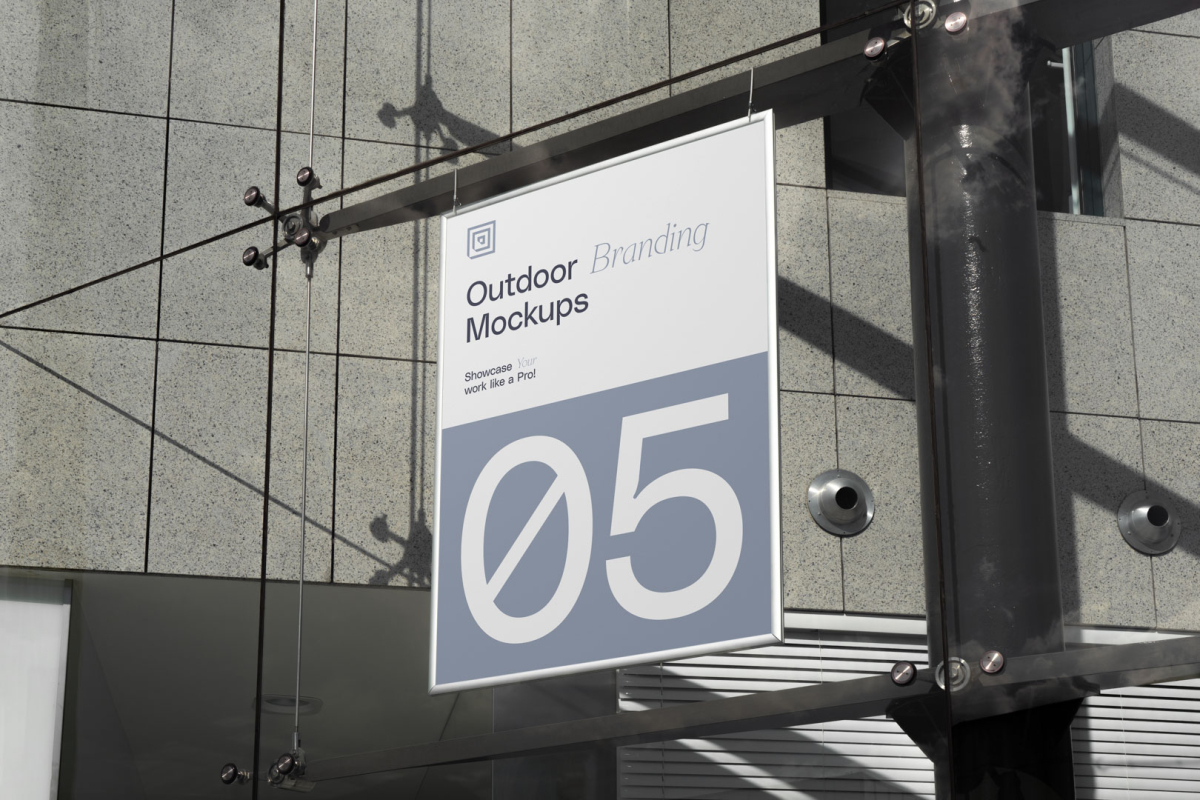 Hanging poster on the modern building from outdoor branding mockups.