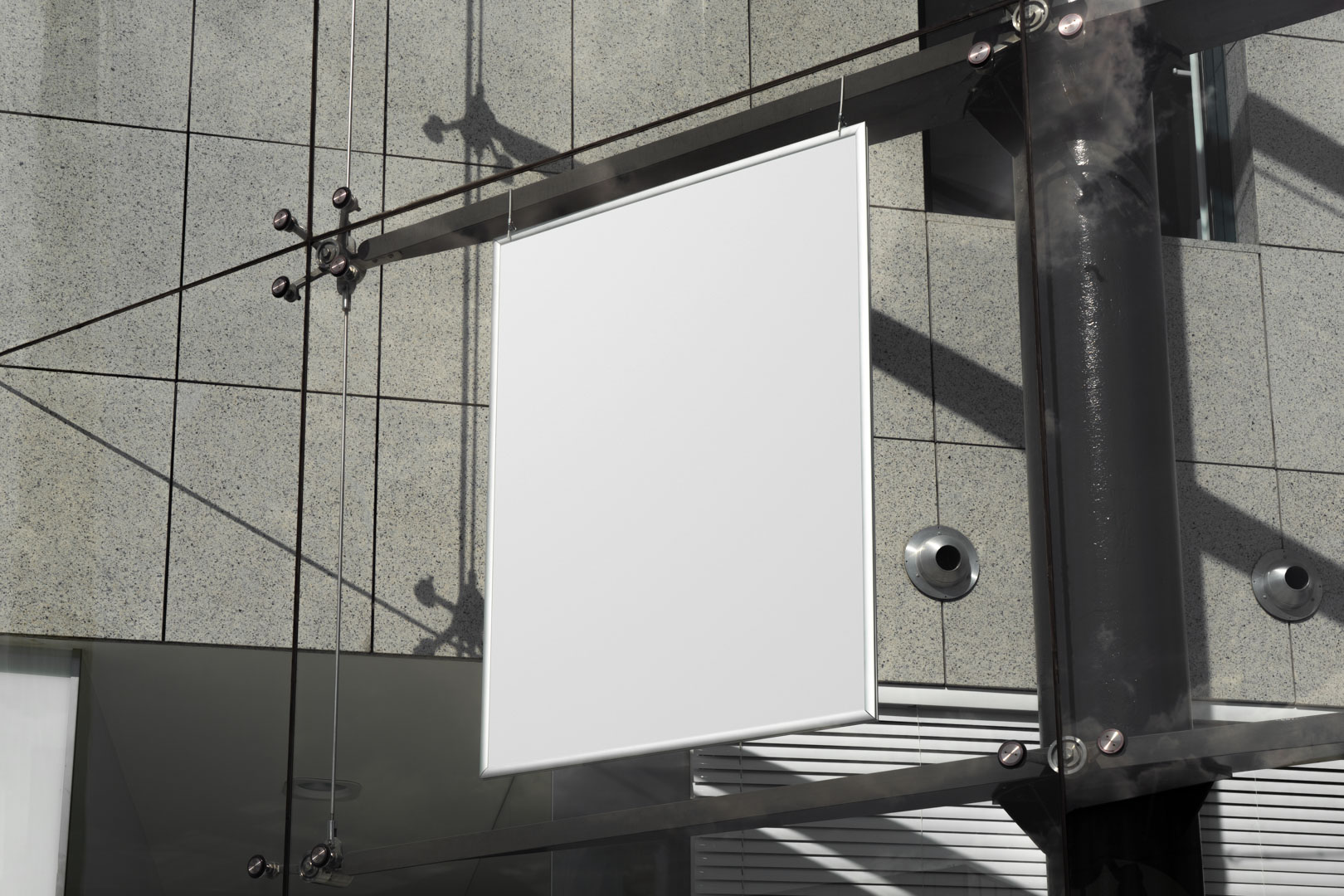 Hanging white poster on the modern building from outdoor branding mockups.