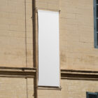 White banner on the old building from outdoor branding mockups.