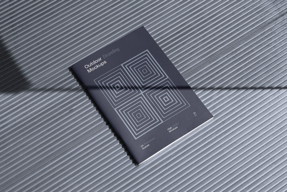 Notebook project with deboss, on the metal floor from outdoor branding mockups.