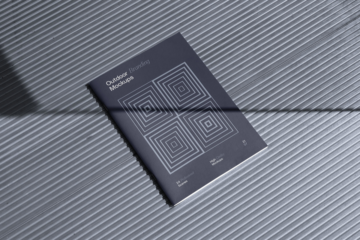 Notebook project with deboss, on the metal floor from outdoor branding mockups.