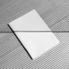 White notebook on the silver metal floor from outdoor branding mockups.