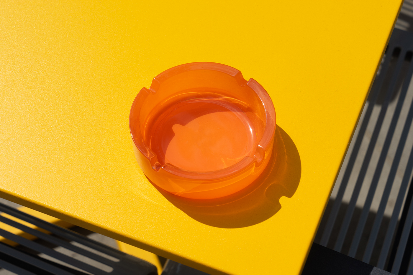 Ashtray Mockup laying on a yellow table.