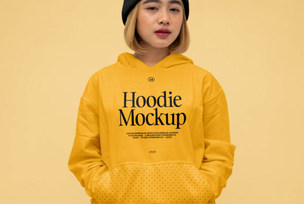 Free Girl Hoodie Mockup in black beanie seen from the front against bright yellow color background.