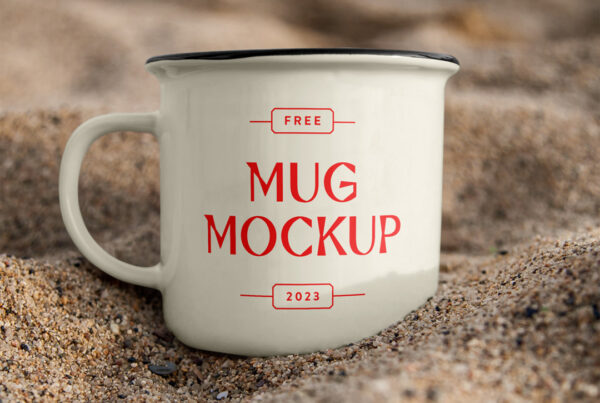 Free Mug Mockup standing between sand.