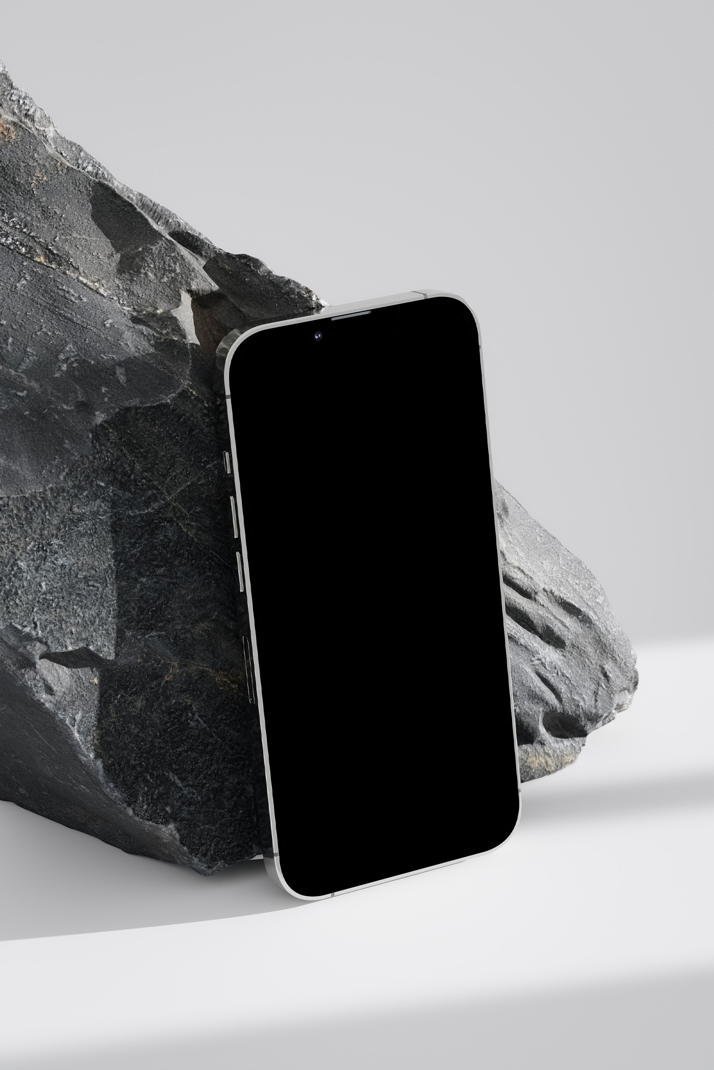 Black screen iPhone Mockup based on rock against gray background color.