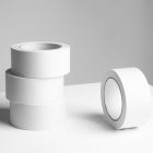 Seen from the front, Four White Branding Mockups Tapes laying on a white table.