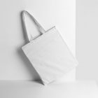 Seen from the front, Blank Canvas Bag Mockup with handle standing on the white table.
