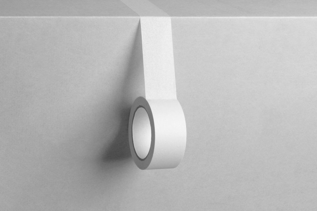 Seen from front unrolled adhesive White Tape Branding Mockup on white box.