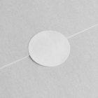 White Circle Sticker Branding Mockup glued to blank business cards, seen from above.