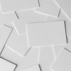 Seen from the above, Scattered White Business Card Branding Mockups on the floor.