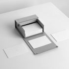 Box of Blank Business Cards Branding Mockups scene seen from above laying on white cubic.