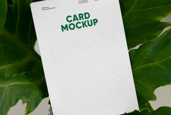 The Free Card Mockup seen from the front is laying between a ficus flower.