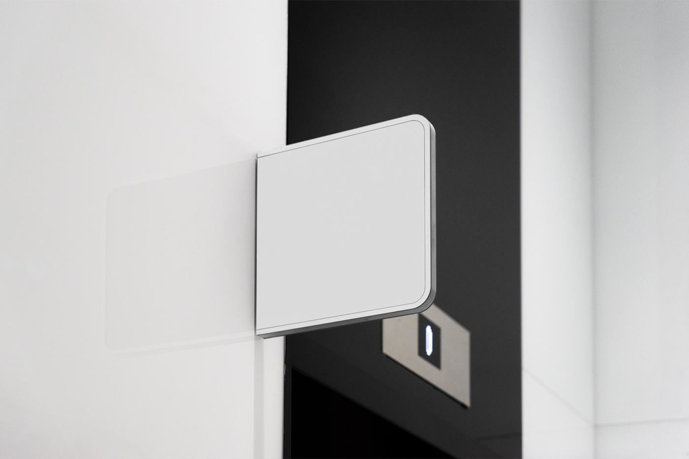 Free Blank Modern Sign Mockup seen from the front is attached to the white wall with silver frame against elevators.