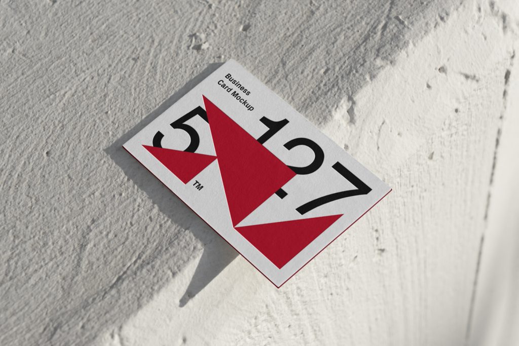 Free Outdoor Business Card Mockup seen from above laying on the cream color concrete.