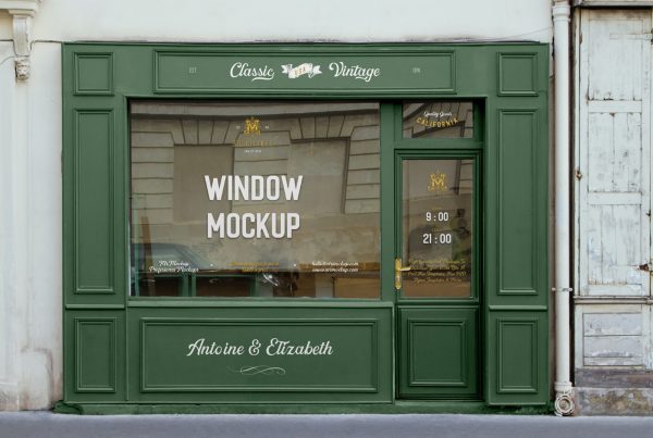 Seen from the front, Free Retail Storefront Mockup in green colors on building and gold colors on windows.