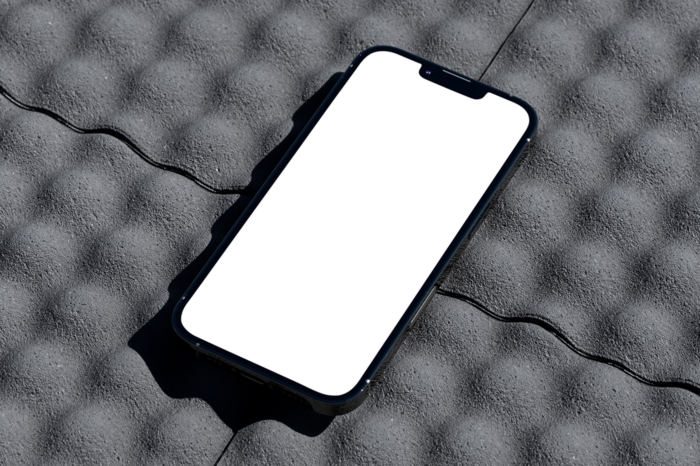 iPhone Pro Mockup with white screen laying on the roof tiles.