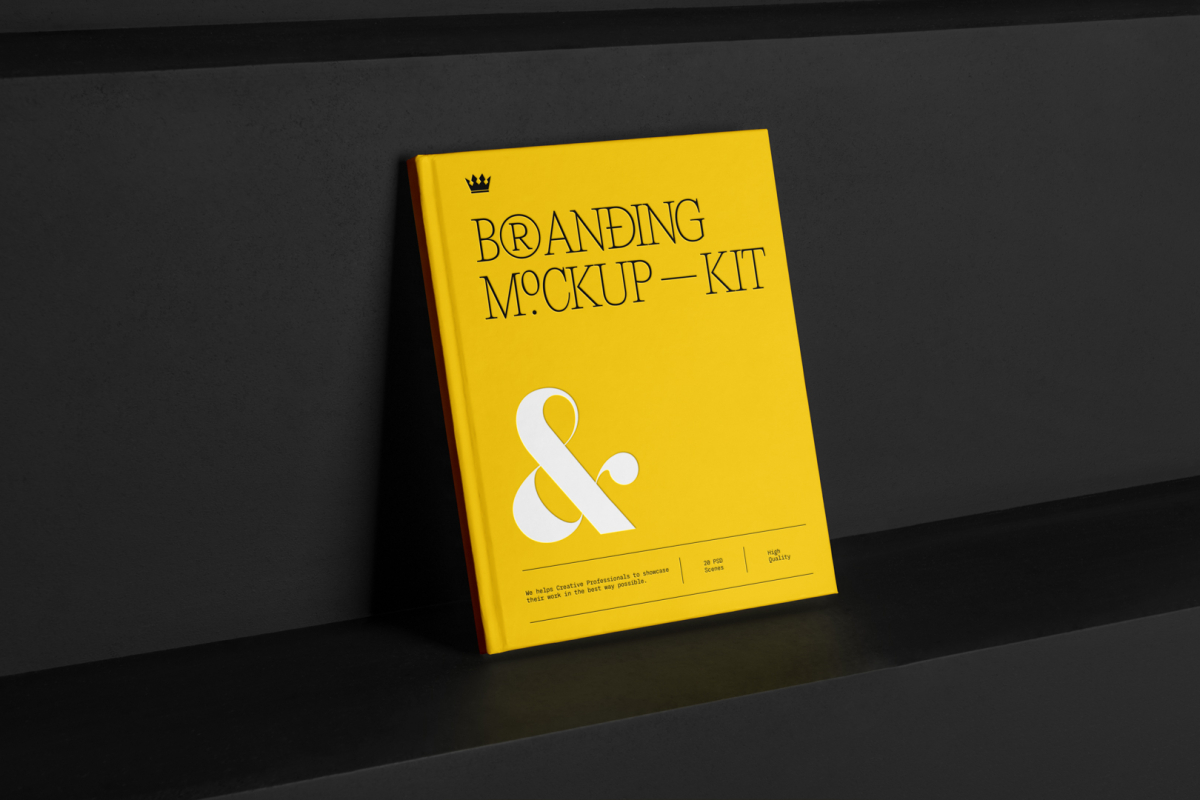 Hardcover Book Branding Mockups Kit with deboss yellow design seen from the front is standing on the black wooden stairs.