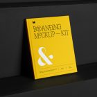 Hardcover Book Branding Mockups Kit with deboss yellow design seen from the front is standing on the black wooden stairs.