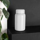 Blank Flask Bottle Branding Mockups Kit, seen from the front, is standing on the black wooden stairs.