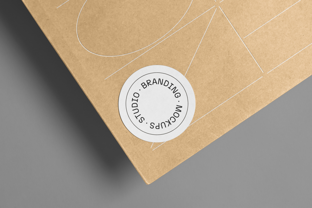 Big zoom on the circle Sticker Branding Mockup glued to craft card against a gray background.