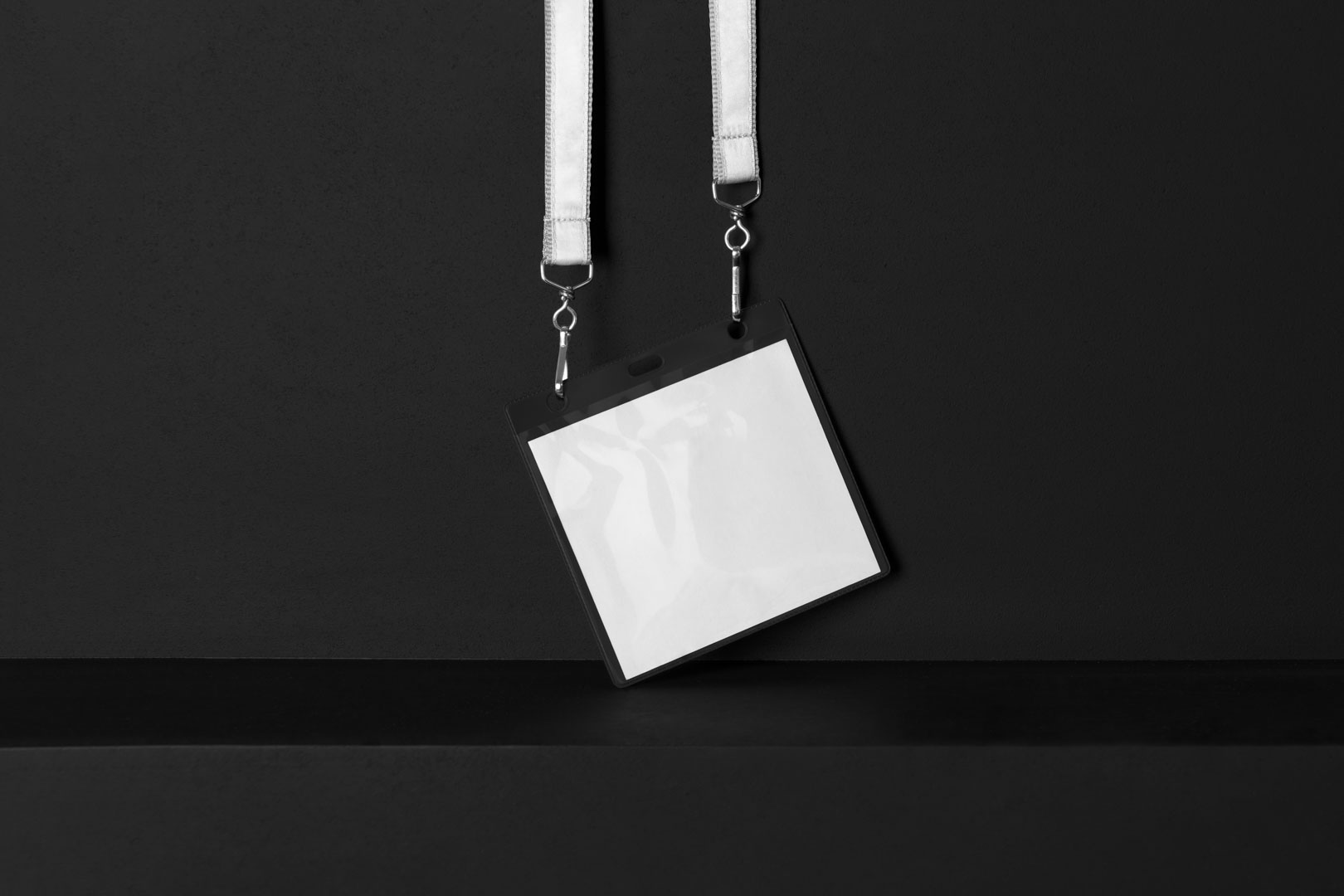 Blank ID Lanyard Branding Mockups Kit seen from front and located on the black wooden stairs.