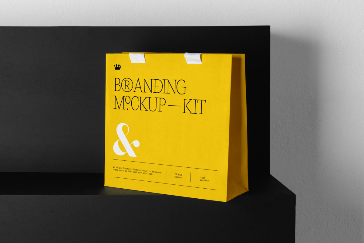 Decorative Paper Bag Branding Mockups Kit with a yellow design seen from front, is standing on the black wooden stairs.