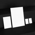 The White Stationery Set like Card, Business Cards Branding Mockups Kit seen from above and located on the black wooden stairs are arranged in nice composition.