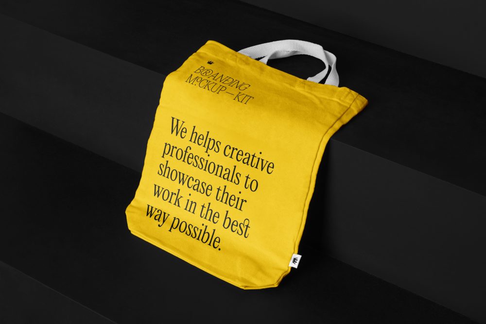 Canvas Bag Branding Mockups Kit with yellow design seen from above and located on the black wooden stairs.