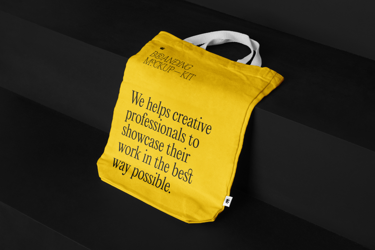 Canvas Bag Branding Mockups Kit with yellow design seen from above and located on the black wooden stairs.