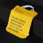 Canvas Bag Branding Mockups Kit with yellow design seen from above and located on the black wooden stairs.