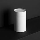 The White Tube Branding Mockups Kit seen from front and located on the black wooden stairs.