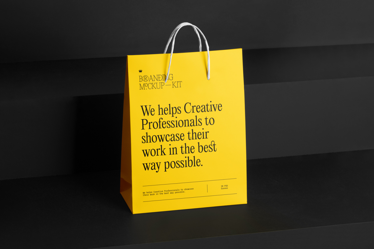 Shopping Bag Branding Mockups Kit with yellow design seen from front and located on the black wooden stairs.