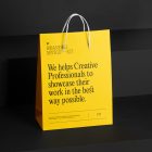 Shopping Bag Branding Mockups Kit with yellow design seen from front and located on the black wooden stairs.