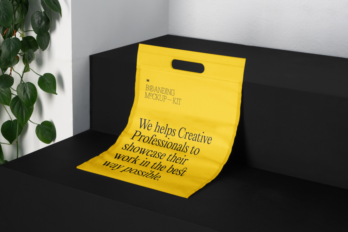 Plastic Shopping Bag Branding Mockups Kit with yellow design seen from above and located on the black wooden stairs.