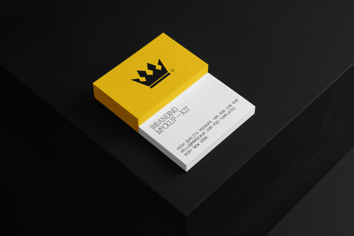 Business Cards Branding Mockups Kit with white and yellow design seen from above and located on the black wooden stairs.