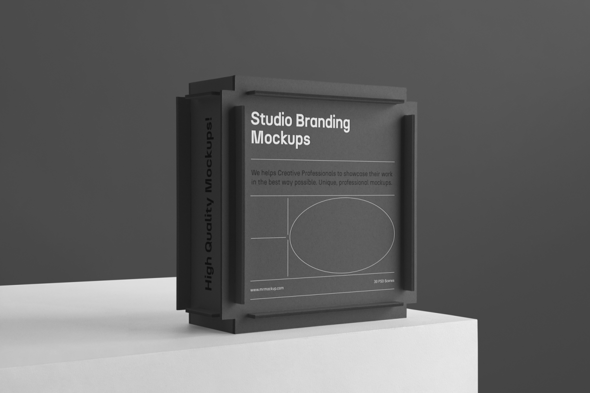 Black Box Branding Mockup standing on the white cubic on a black background and is seen from the front.