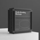 Black Box Branding Mockup standing on the white cubic on a black background and is seen from the front.