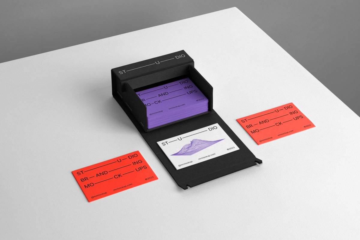 Box of Business Cards Branding Mockups scene seen from above with colorful design laying on white cubic.