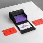 Box of Business Cards Branding Mockups scene seen from above with colorful design laying on white cubic.