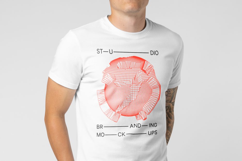 Men seen from front standing and wearing T-Shirt Branding Mockup against a white wall.