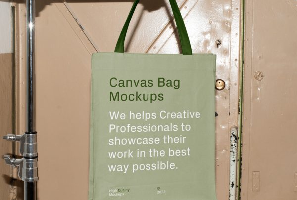 Front view, Free Canvas Bag Hanging on Tripod Mockup with bright-green design colors against vintage magazine door in beige color.