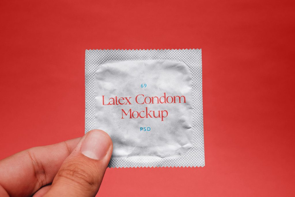 Front view, Free Condom in Hand Mockup with simple typography design against a red background color.