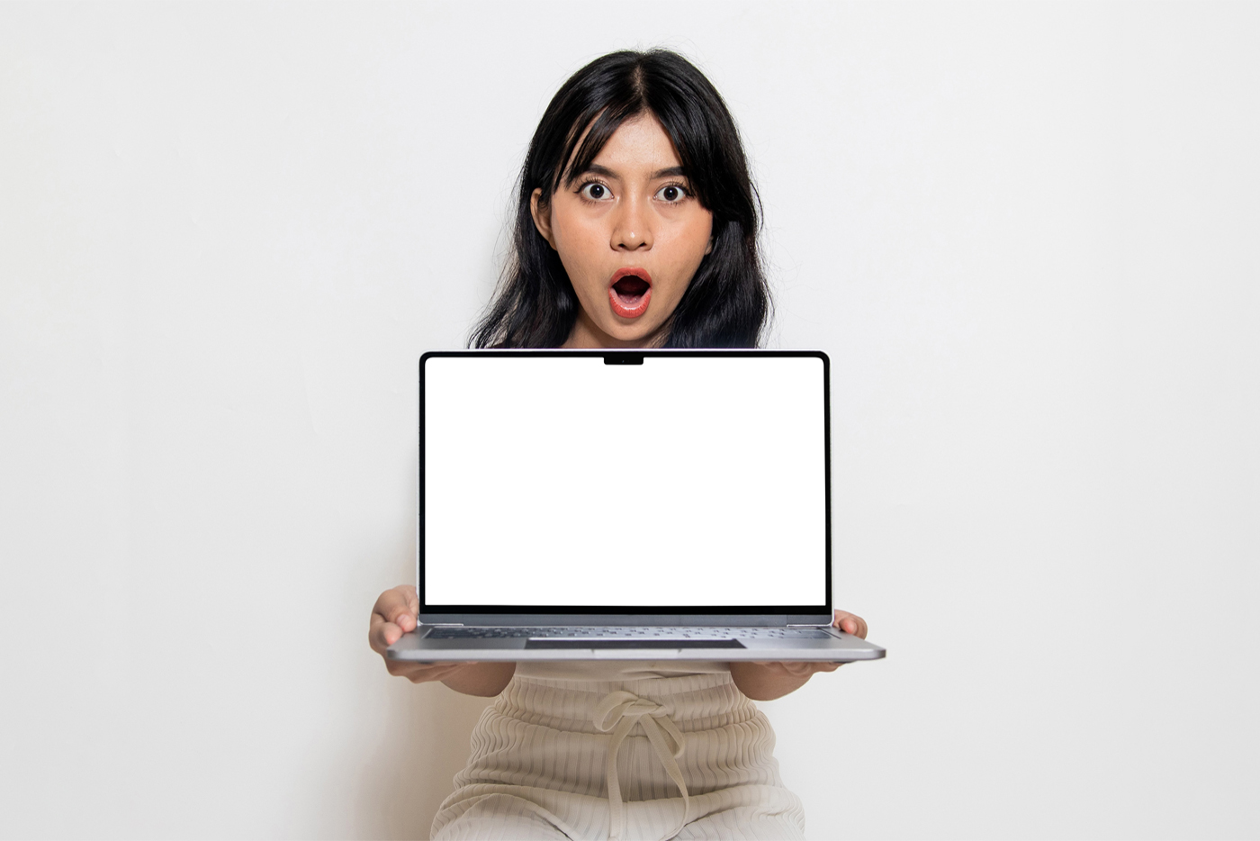 Free front view, White screen Free MacBook Pro Mockup held in the hands of a woman against white wall in the background.