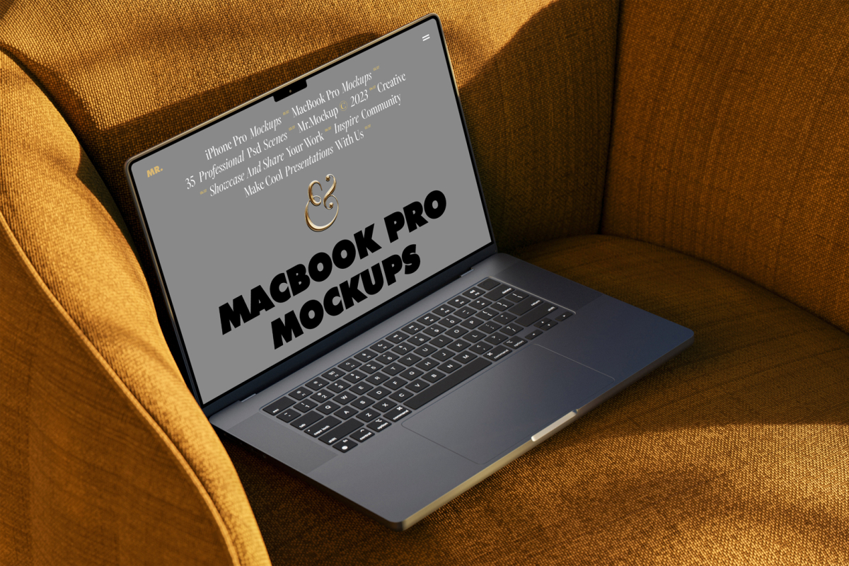 Seen from above, space gray MacBook Pro Mockup with gray design laying on the reddish yellow couch.