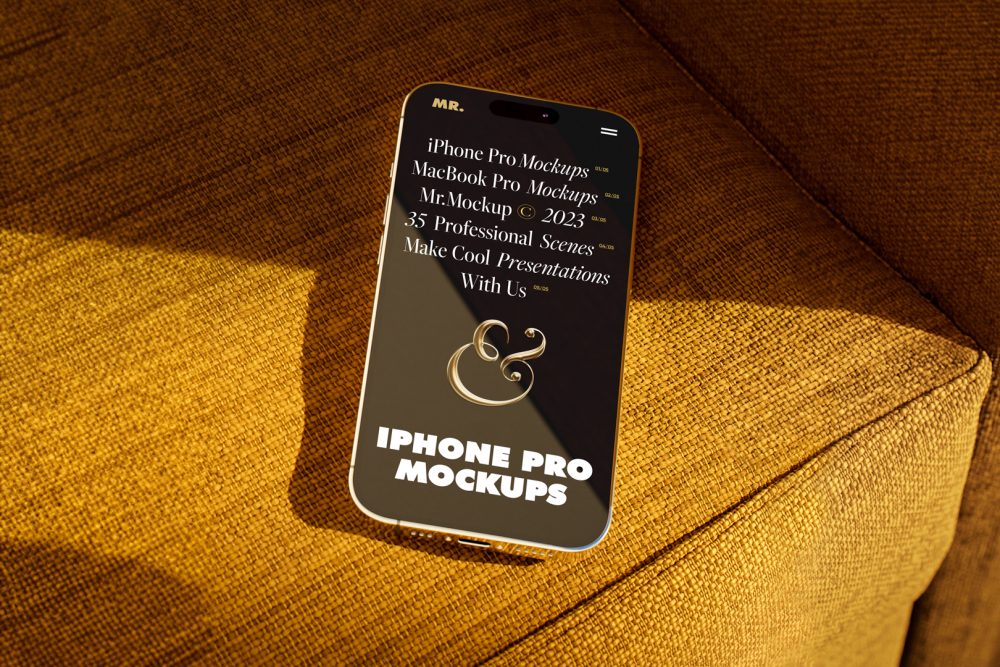 Seen from above, gold iPhone 14 Pro Mockup with black design laying on the reddish yellow couch.