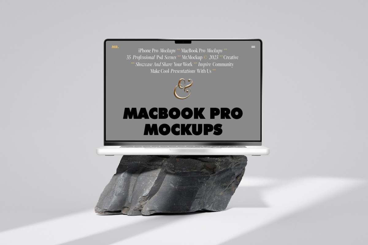 Front view, MacBook Pro Mockup with gray design standing on the big rock against a bright gray background.