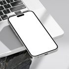Seen from above, blank iPhone 14 Pro Mockup laying on the MacBook standing on the big rock against a bright gray background.